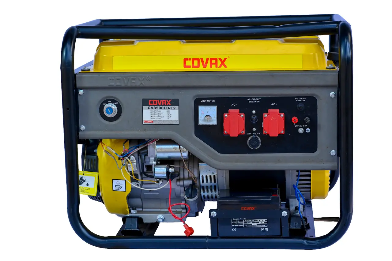 Side profile of the COVAX 6.5kW generator showcasing the electric start battery and robust steel frame